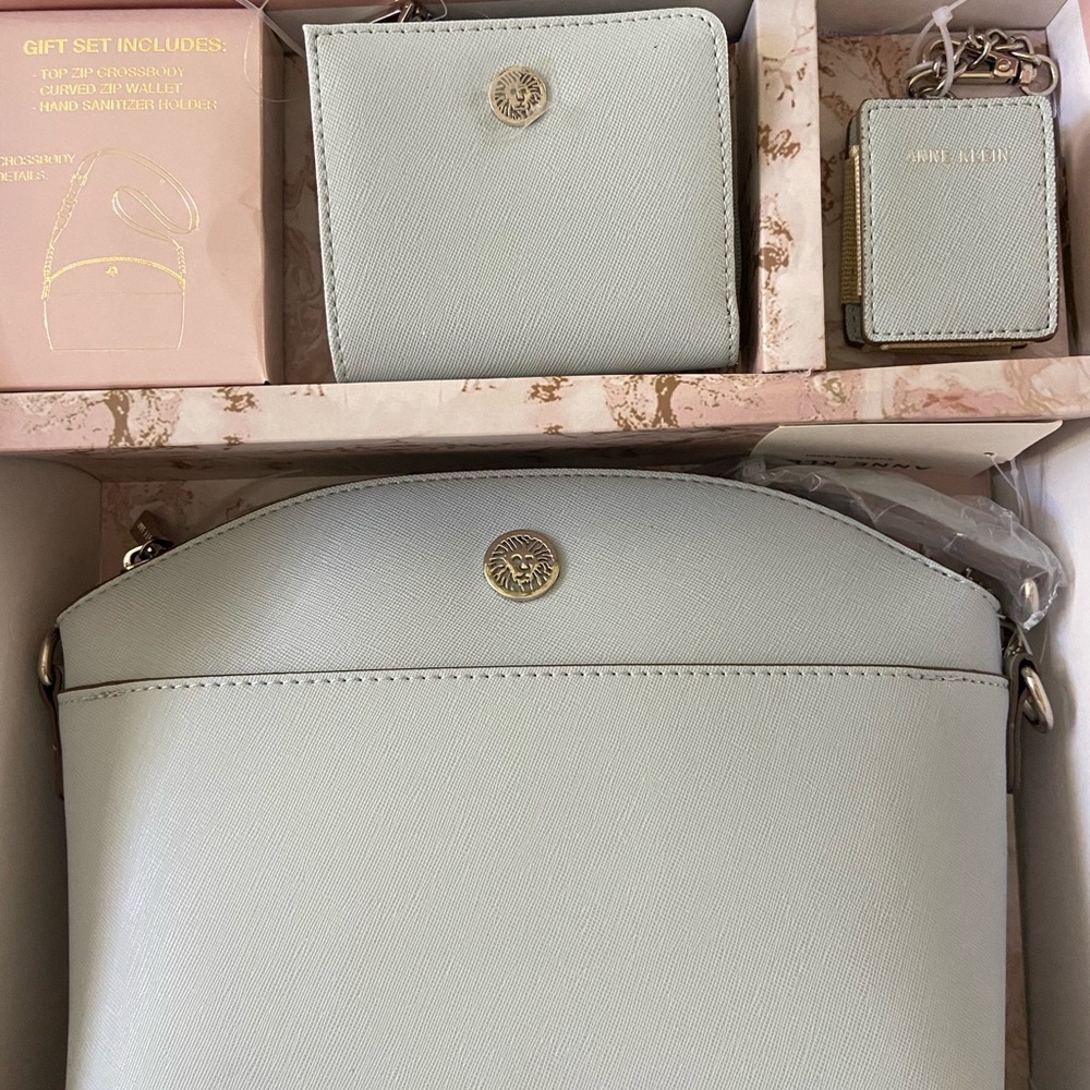Anne Klein top zip crossbody, curved zip wallet, & hand sanitizer holder.